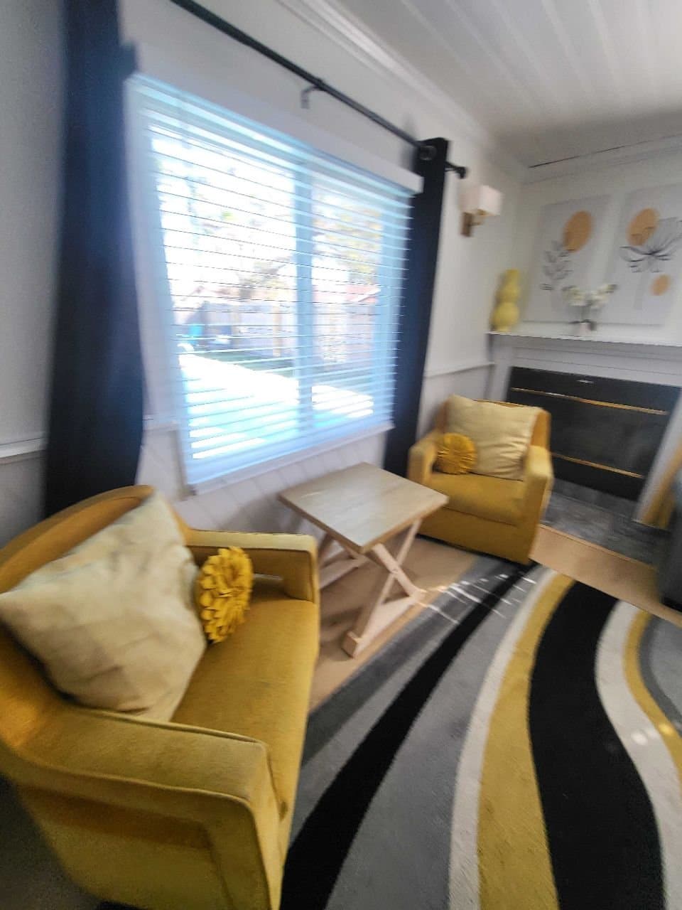 Sitting room with yellow accent chairs after a CLH clean